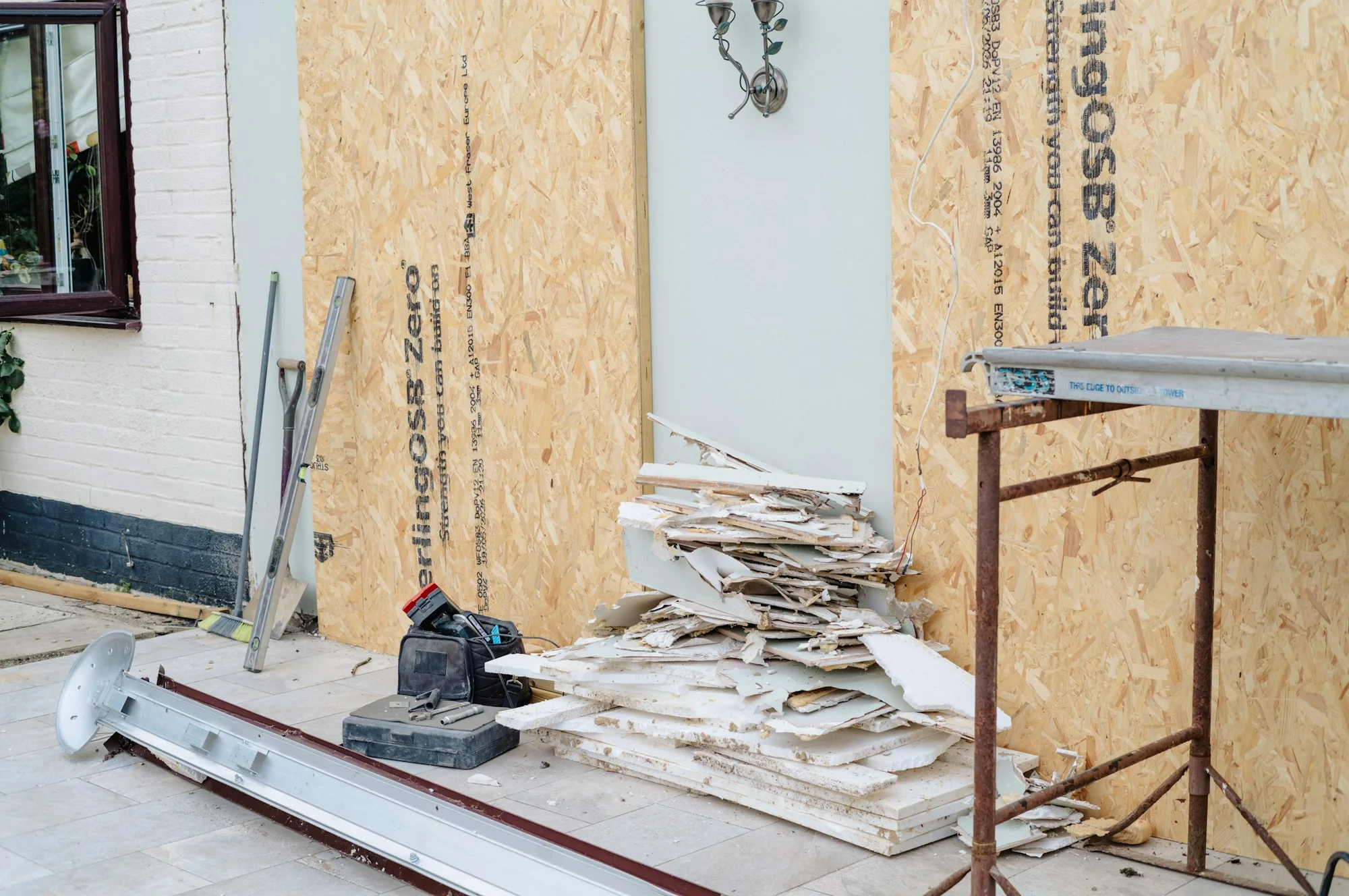 Residential renovation work in progress with exposed exterior sheathing